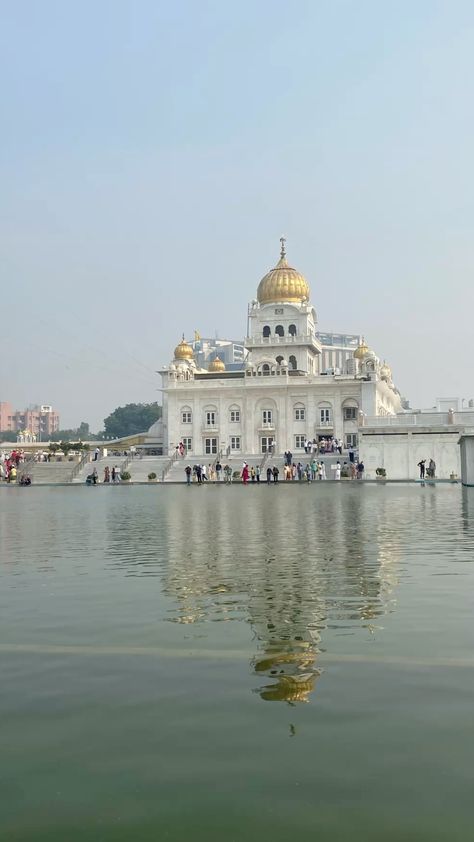 This may contain: a large white building sitting on top of a lake