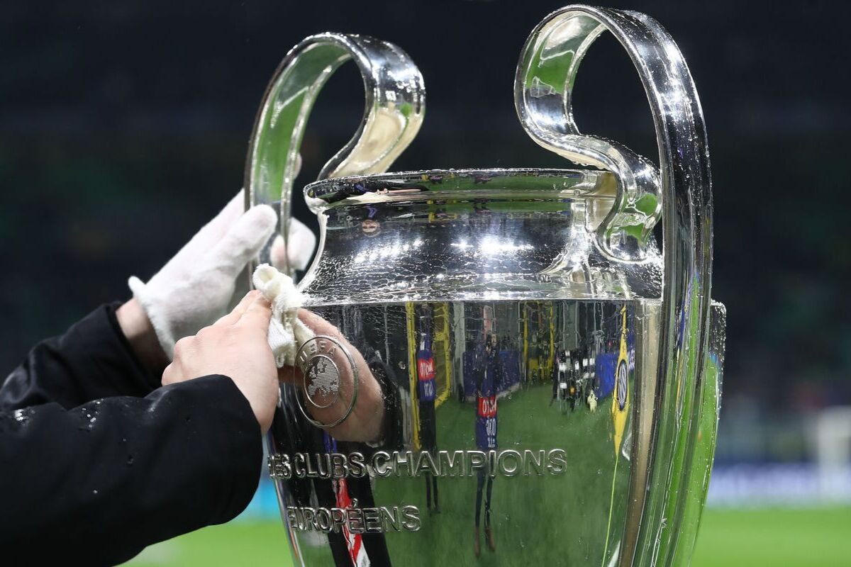 MILAN, ITALY - MARCH 11: The UEFA Champions League trophy is cleaned as it is displayed on a plinth at the side of the pitch prior to the UEFA Champions League 2024/25 UEFA Champions League 2024/25 Round of 16 Second Leg match between FC Internazionale Milano and Feyenoord at Stadio Giuseppe Meazza on March 11, 2025 in Milan, Italy. (Photo by Marco Luzzani/Getty Images)