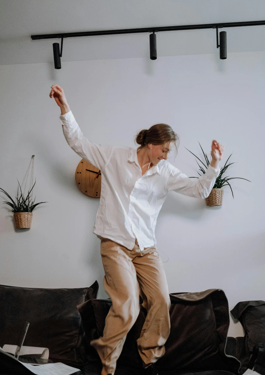 woman dancing to music on Spotify
