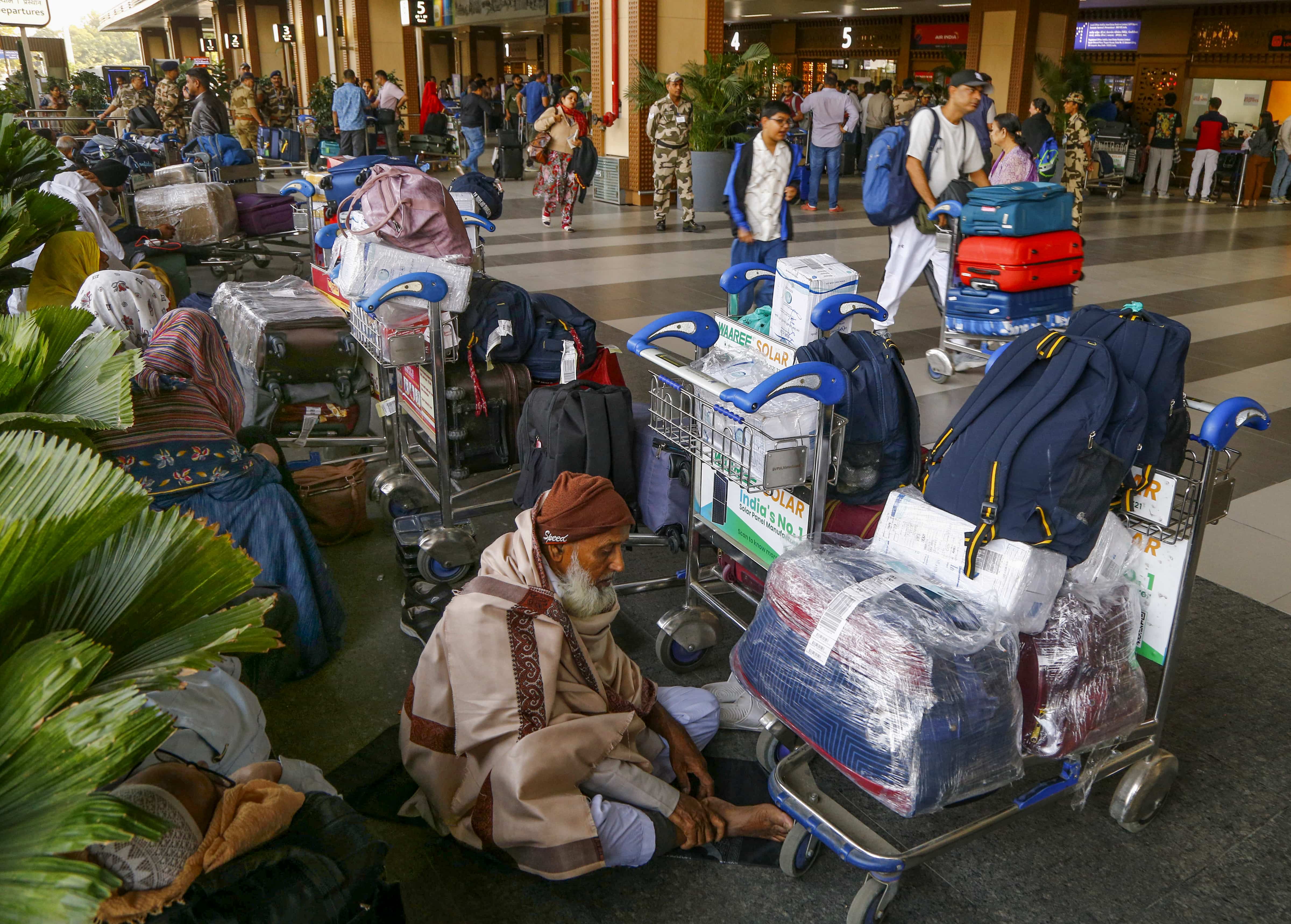 Elderly people were seen sitting with luggage at Ahmedabad airport.
