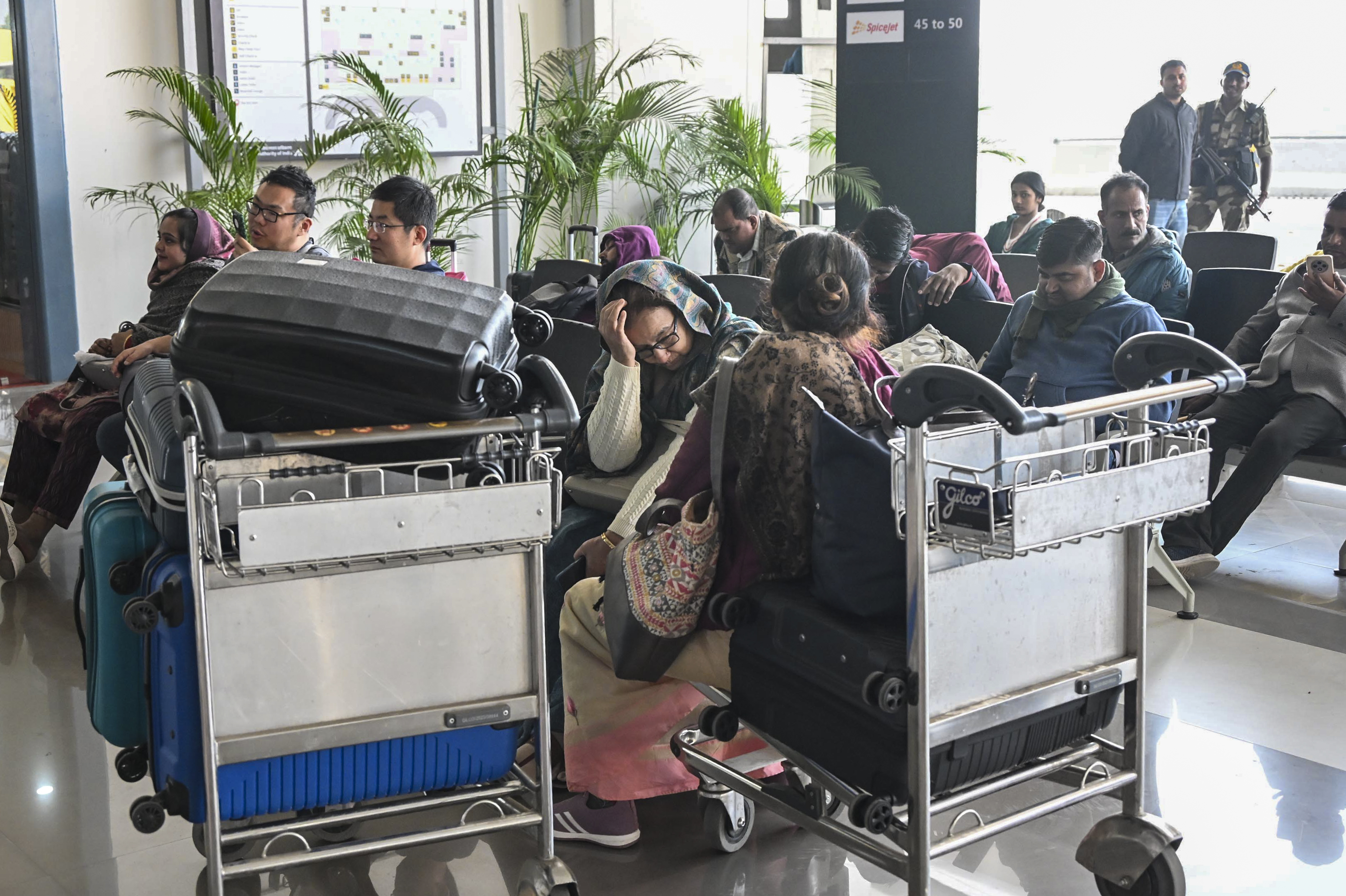 Passengers sitting waiting for flight at Patna airport.