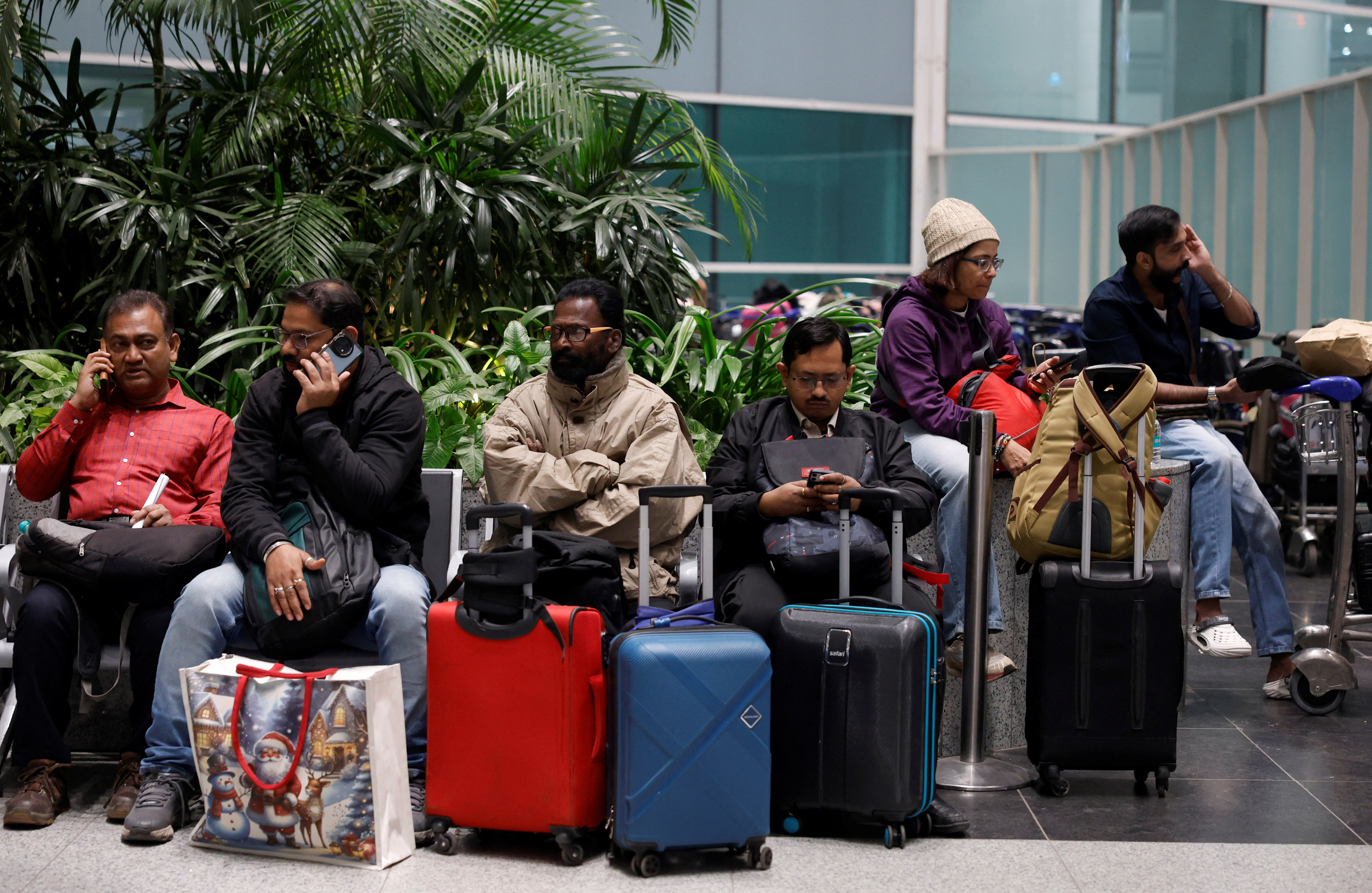 Passengers were seen sitting at Delhi airport after the flight was cancelled.