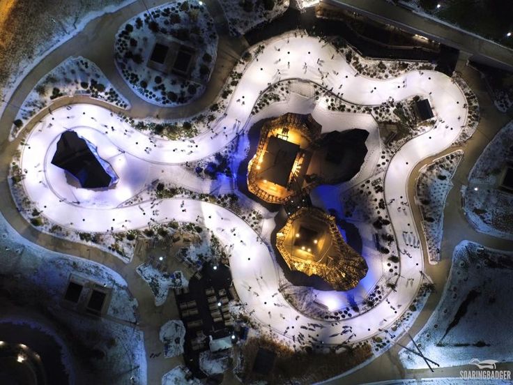 This may contain: an aerial view of some buildings lit up at night