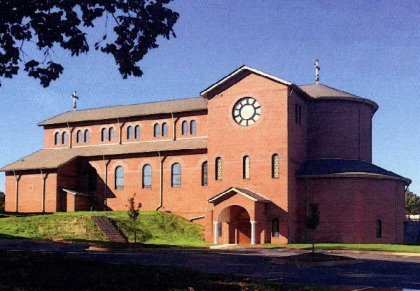 This may contain: a large brick building with a clock on the front