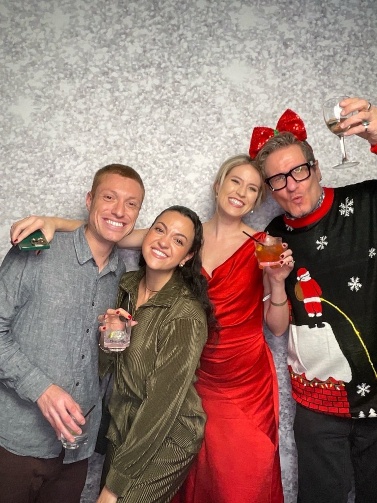 Four people posing for a photo, dressed for a holiday fashion story.