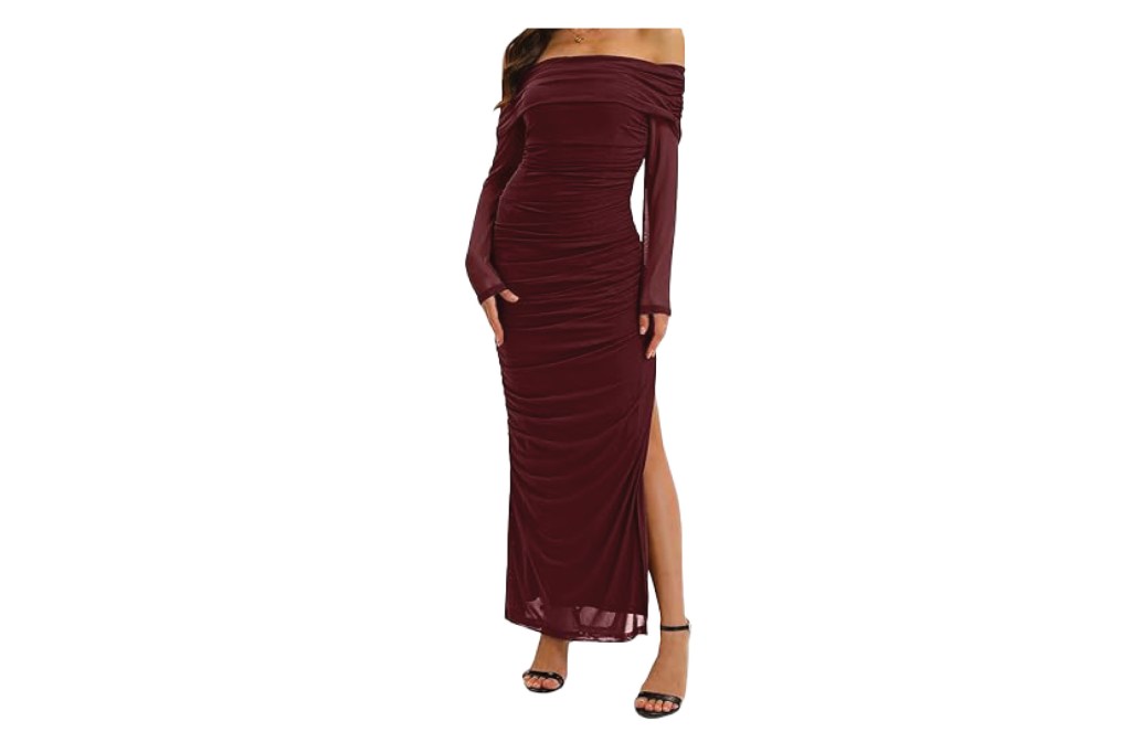 Woman wearing a long burgundy off-the-shoulder dress with a high slit.