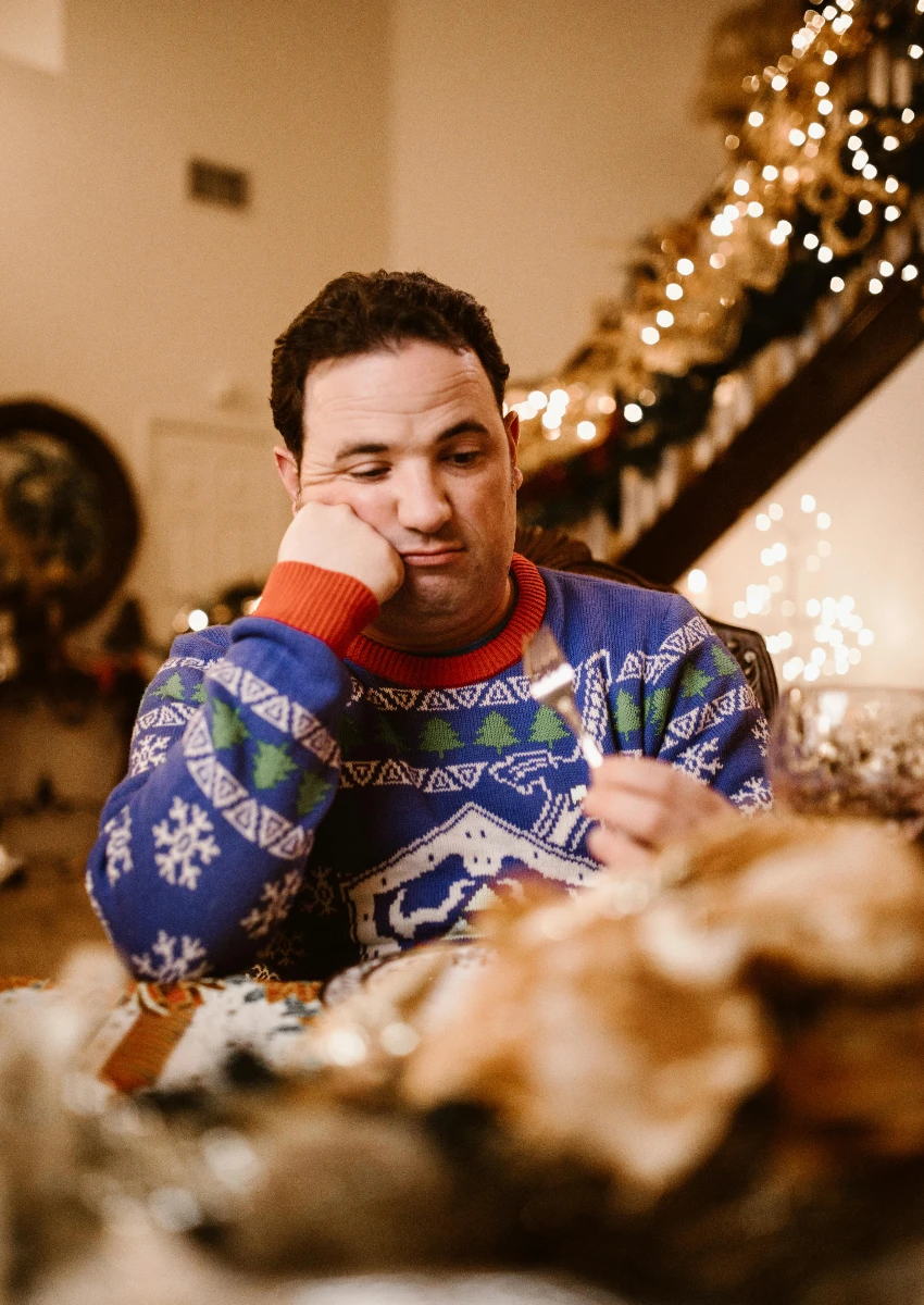 gen z man eating Christmas dinner with his family