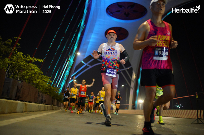 Noel Bizeul waves to the camera on the 42 km course at Read Marathon Hai Phong 2025. Photo courtesy of Read Marathon
