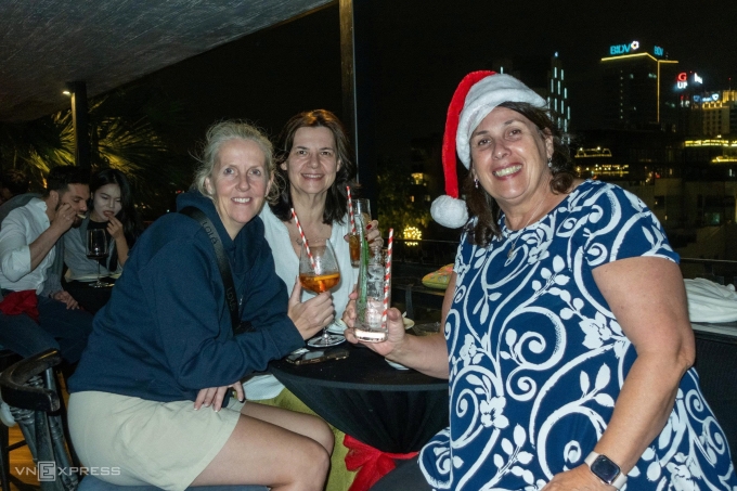 Three British tourists (from right to left), Diana, Claire, and Annalisa, celebrate their first Christmas in Vietnam. Photo by Anh Tu