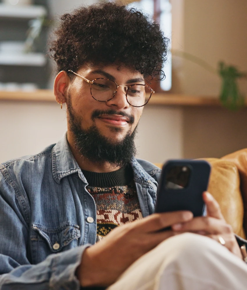 gen z man using phone on couch