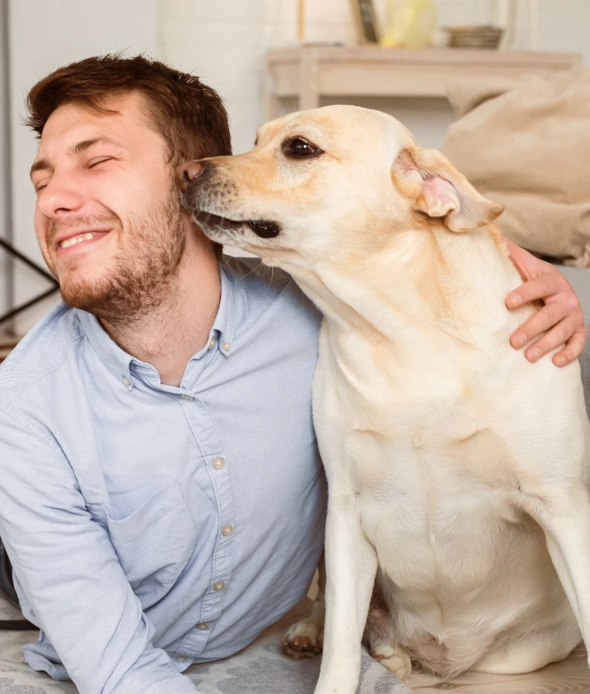 dog sniffing man's ear