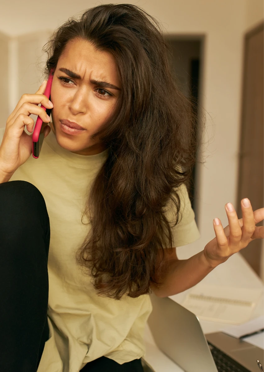 woman talking with her hands while on the phone