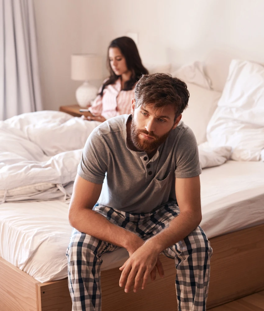 couple ignoring each other in the bedroom