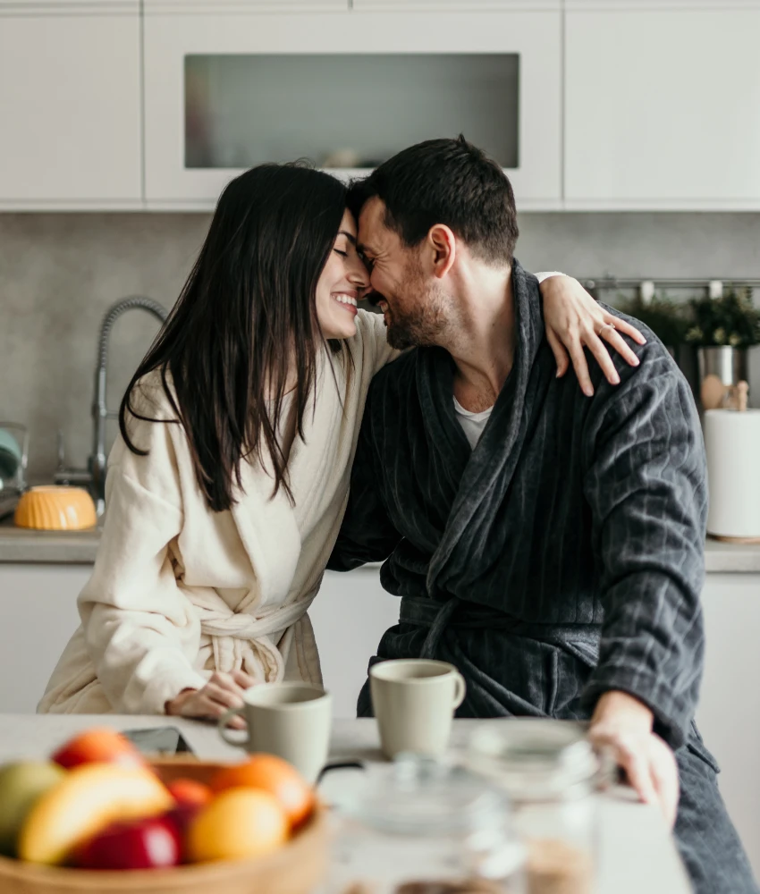 couple showing affection in kitchen