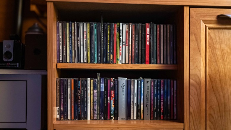 The author's CD collection on two shelves in a wooden desk.