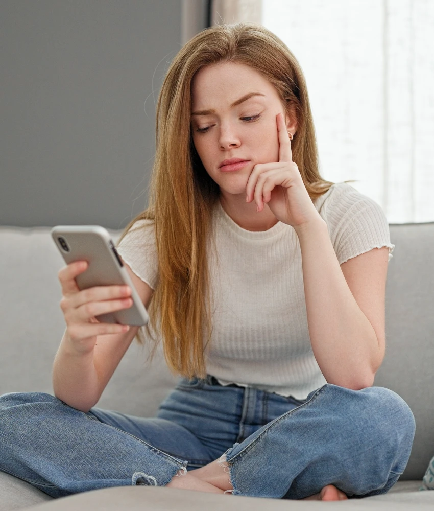 millennial woman using outdated smartphone