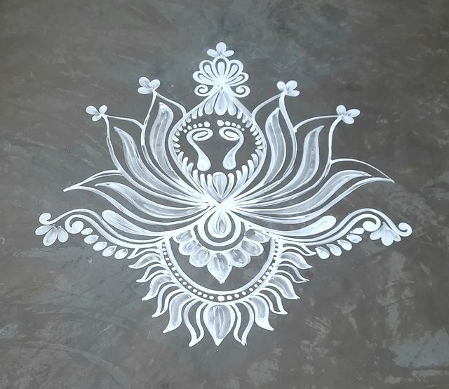 This may contain: an intricately designed design on the ground in white ink, with flowers and leaves