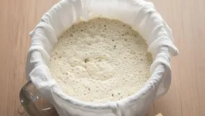 Fermented sabudana batter in cloth-lined bowl.