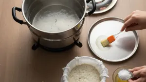 Greasing plate for steaming batter.