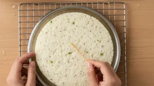 Checking dhokla doneness with toothpick.
