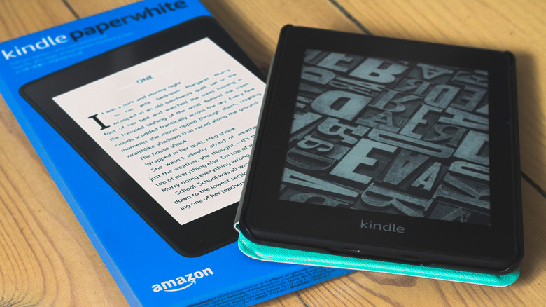 A new Kindle Paperwhite sitting next to its original blue box