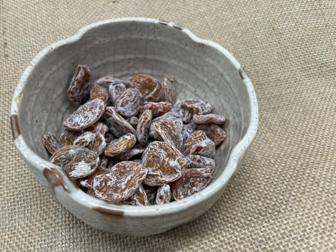 O mai is often covered with a powdery layer created by its high sugar and salt concentration. Photo by Read/Khue Lam