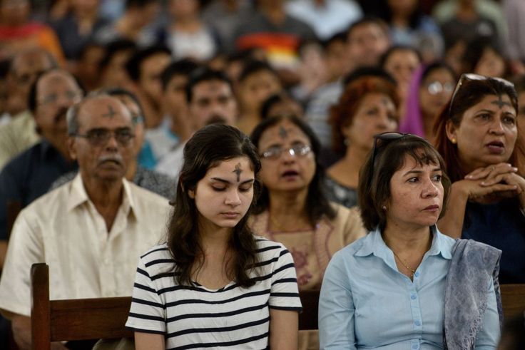 This may contain: several people are sitting in the audience with their eyes closed