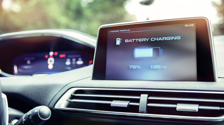 In-dash touch screen on EV automobile displaying the battery's charging rate