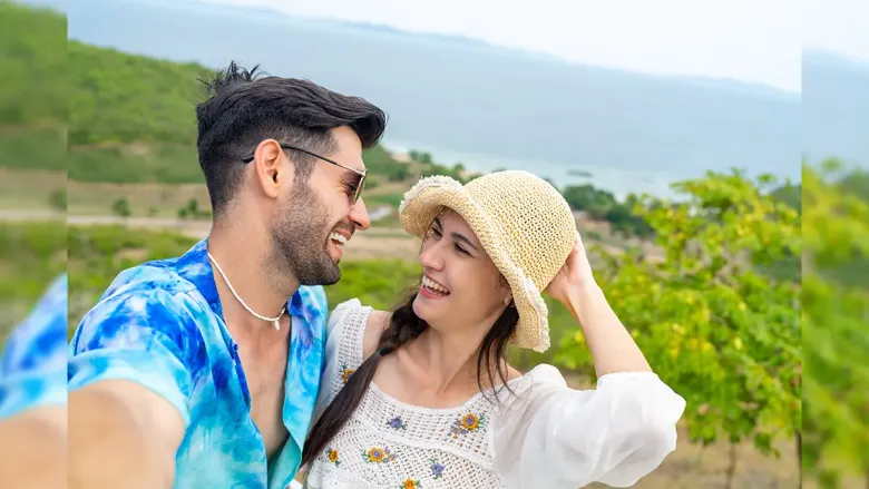 man taking selfie while looking at his partner