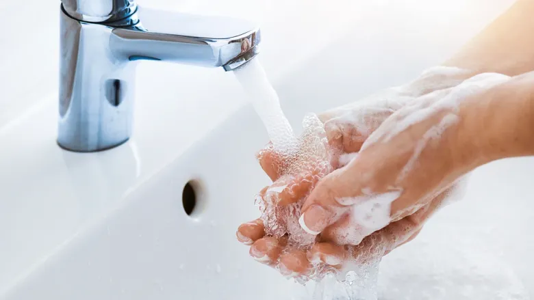 woman hand washing in wash basin
