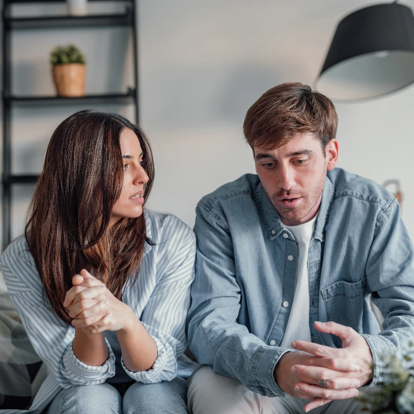 man and woman talking on couch weird places trap bad energy