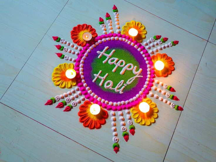 This may contain: a happy holi with candles and flowers on the floor for diwaling or decorating