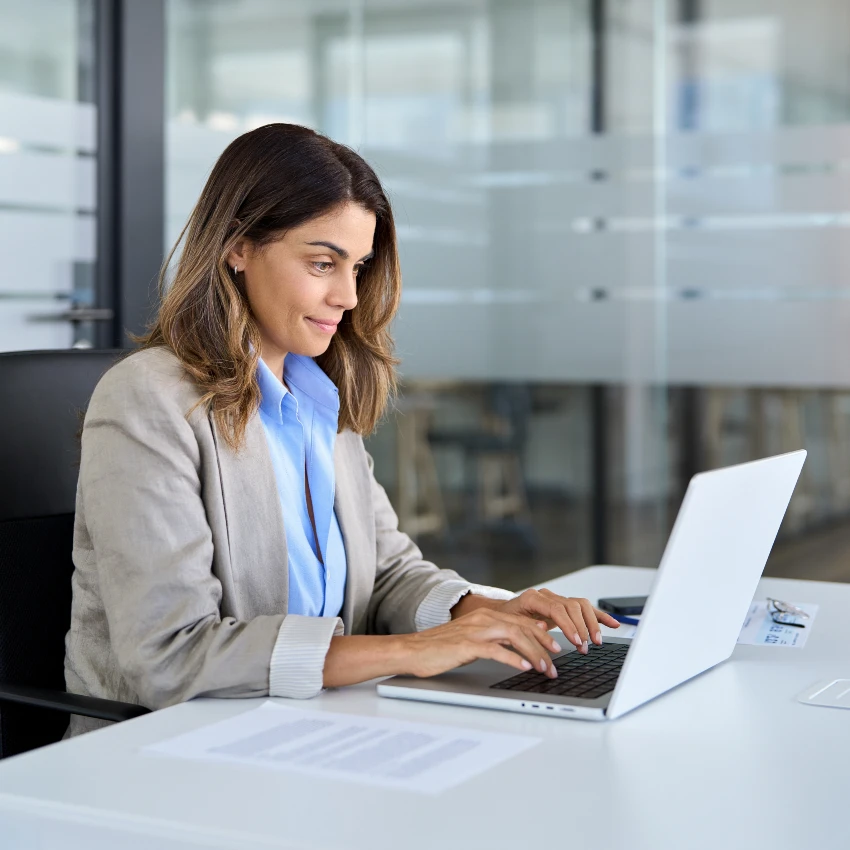 woman typing message on laptop