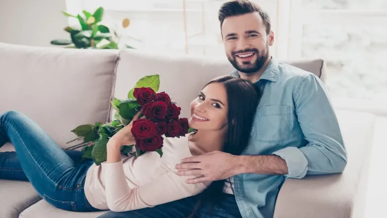 woman is holding rose bouquet with her partner
