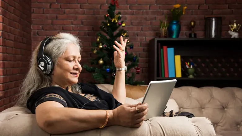 woman listing to music sitting on sofa