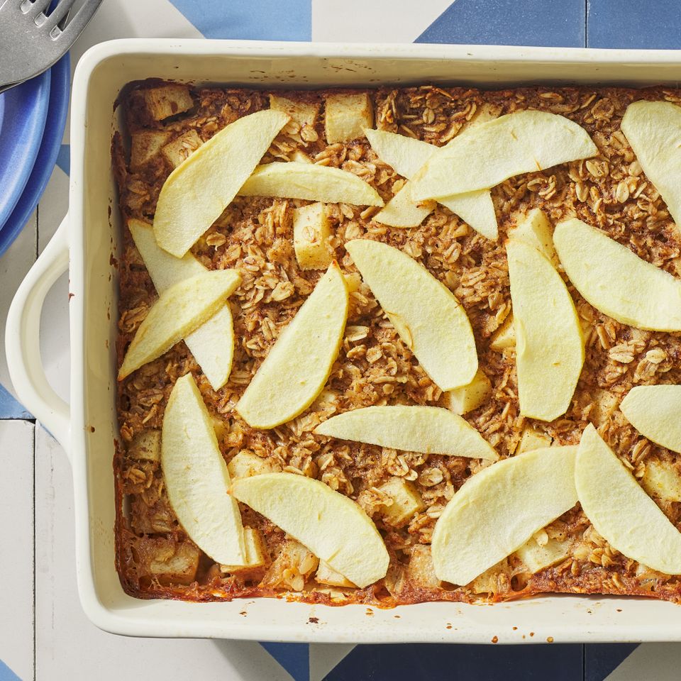 Overhead view of Baked Apple Oatmeal recipe in a white baking dish Credit: Photographer: Fred Hardy, Food Stylist: Jennifer Wendorf, Prop Stylist: Shell Royster