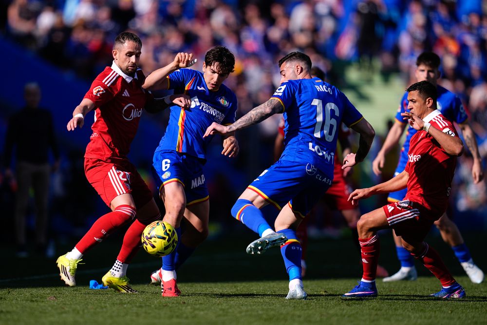 Januzaj competes for a ball in a crowded midfield.