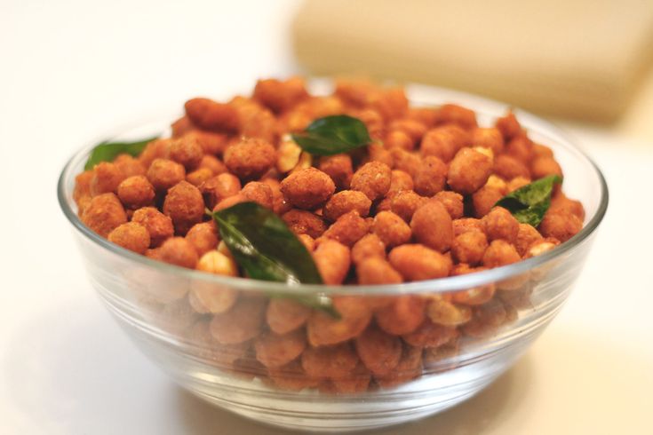 This may contain: a glass bowl filled with chickpeas and spinach