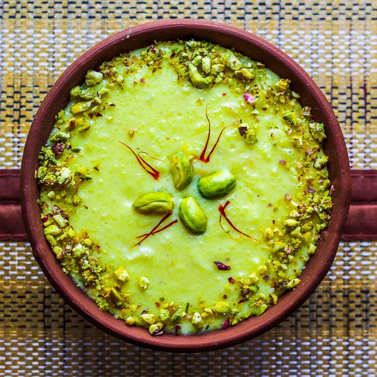 This may contain: a bowl filled with green food on top of a table