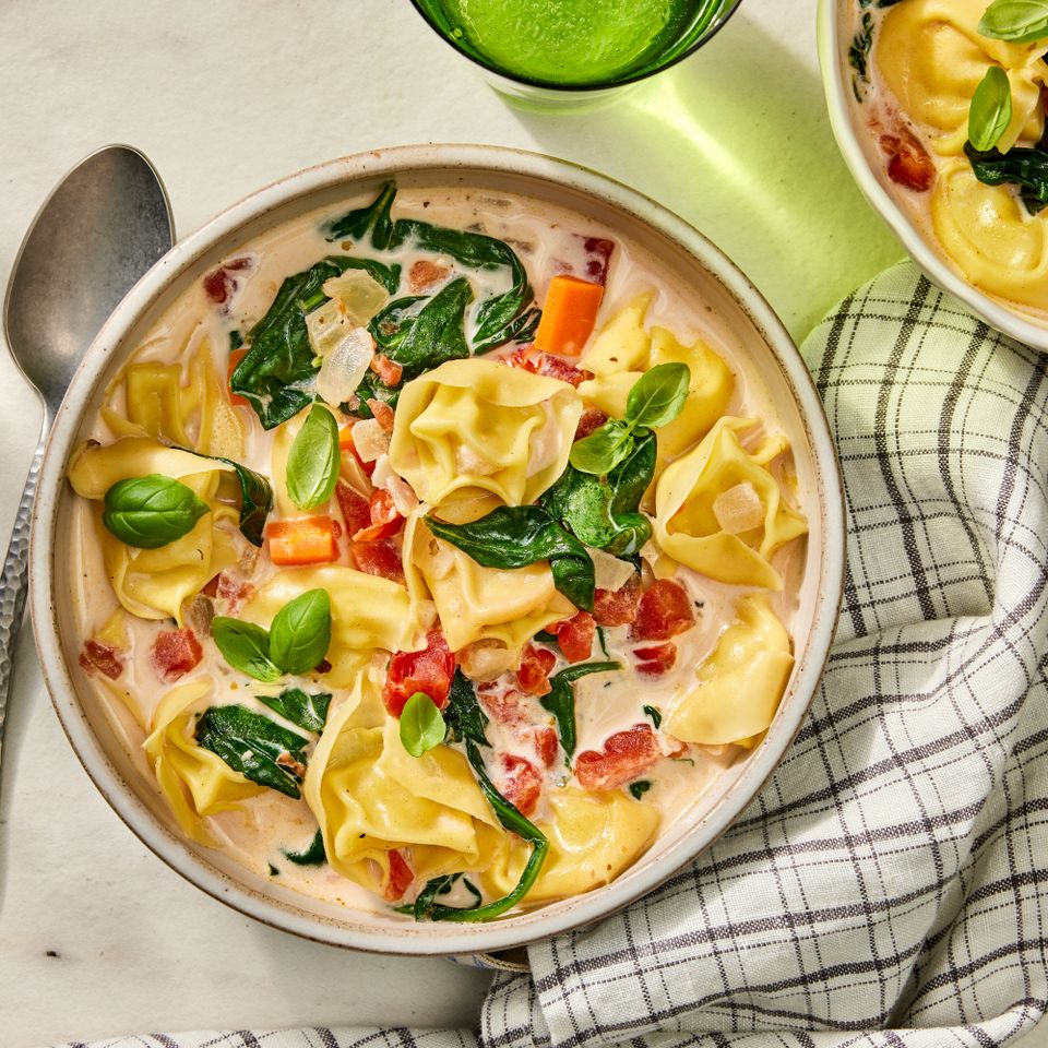an image of the Creamy Tortellini Vegetable Soup Credit: Photographer: Robby Lozano, Food Stylist: Emily Nabors Hall, Prop Stylist: Lydia Pursell