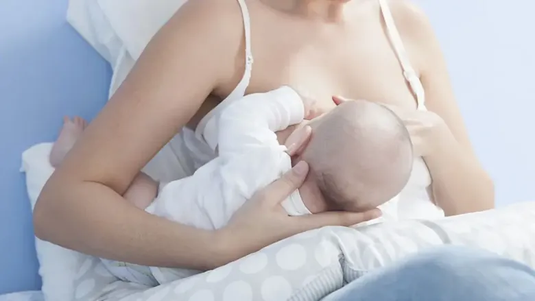 woman breastfeeding her child