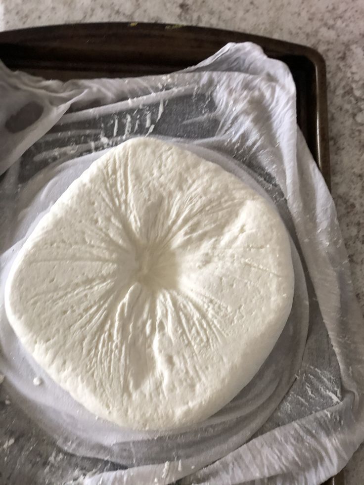 This may contain: an uncooked pizza sitting on top of a pan