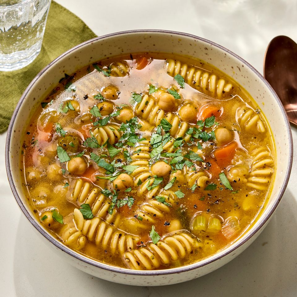 Recipe image of Chickpea Noodle Soup Credit: Photographer: Robby Lozano, Food Stylist: Chelesa Zimmer, Prop Stylist: Lindsey Lower.