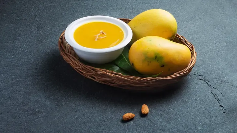 two amnoes and a bowl of mango juice in a tary