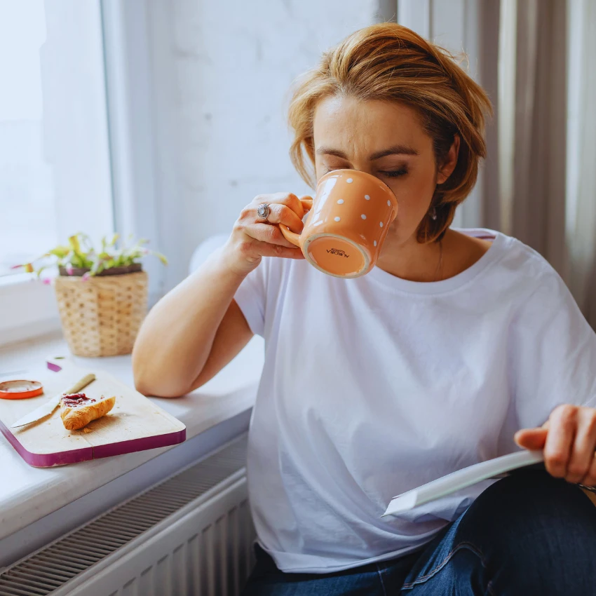 woman having coffee with breakfast