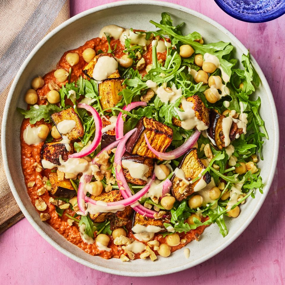A bowl of food with chickpeas roasted vegetables greens and sauce Credit: Photographer: Greg Dupree, Prop Stylist: Julia Bayless, Food Stylist: Chelsea Zimmer
