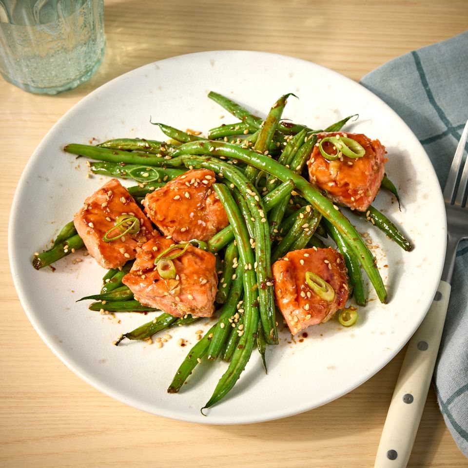 A recipe image of One-Skillet Garlicky Salmon and Green Beans Credit: Photographer: Jen Causey, Food Stylist: Emily Nabors Hall, Prop Stylist: Claire Spollen.