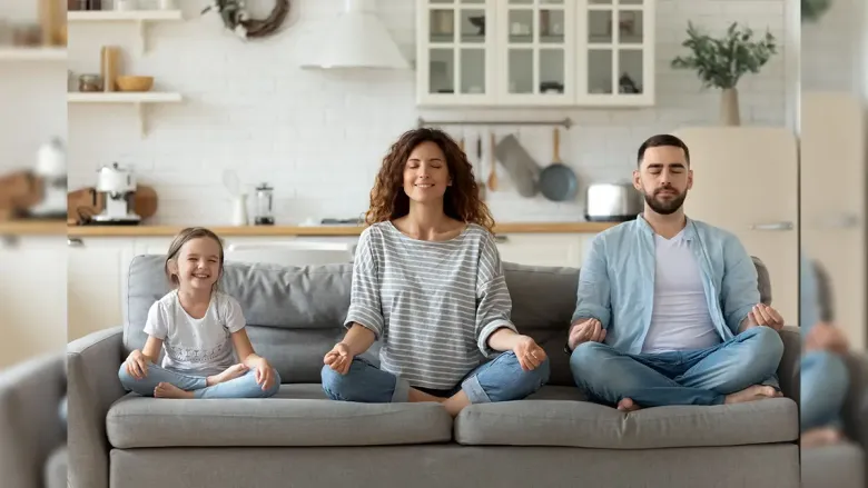 a family of three on sofa meditating cheerfully