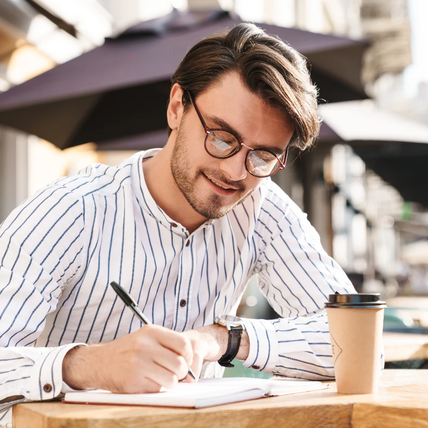 man writing while using metacognition