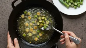Frying bhindi in pan.